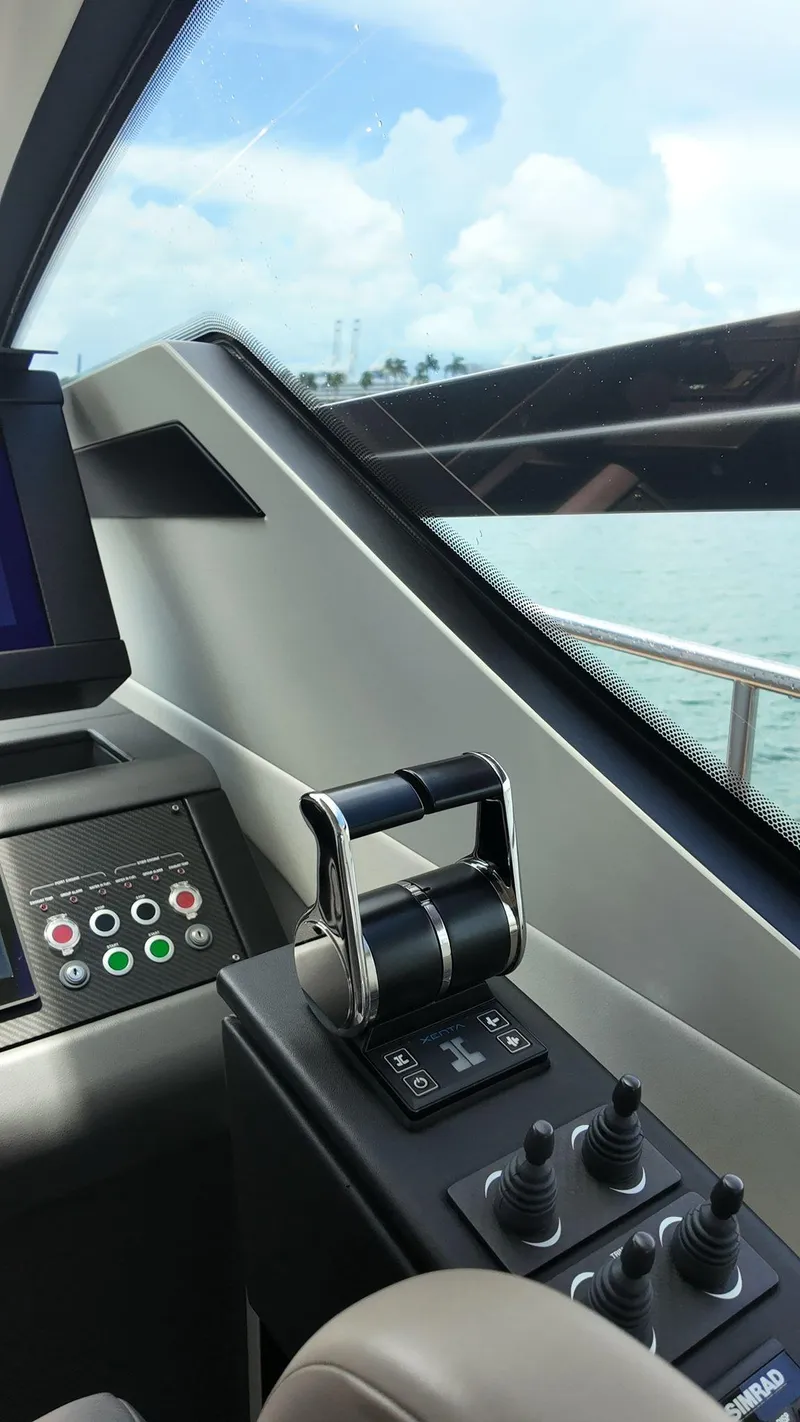 Slide: The Image of Control panel of 2022 Pershing 6X yacht, featuring throttle and joystick controls. - 26