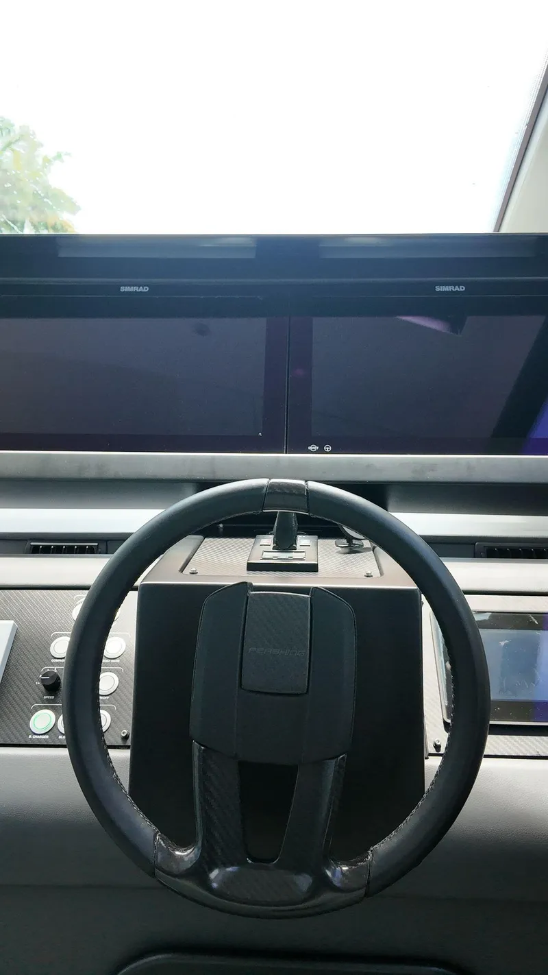 Slide: The Image of Cockpit of 2022 Pershing 6X yacht with dual Simrad displays and steering wheel. - 27
