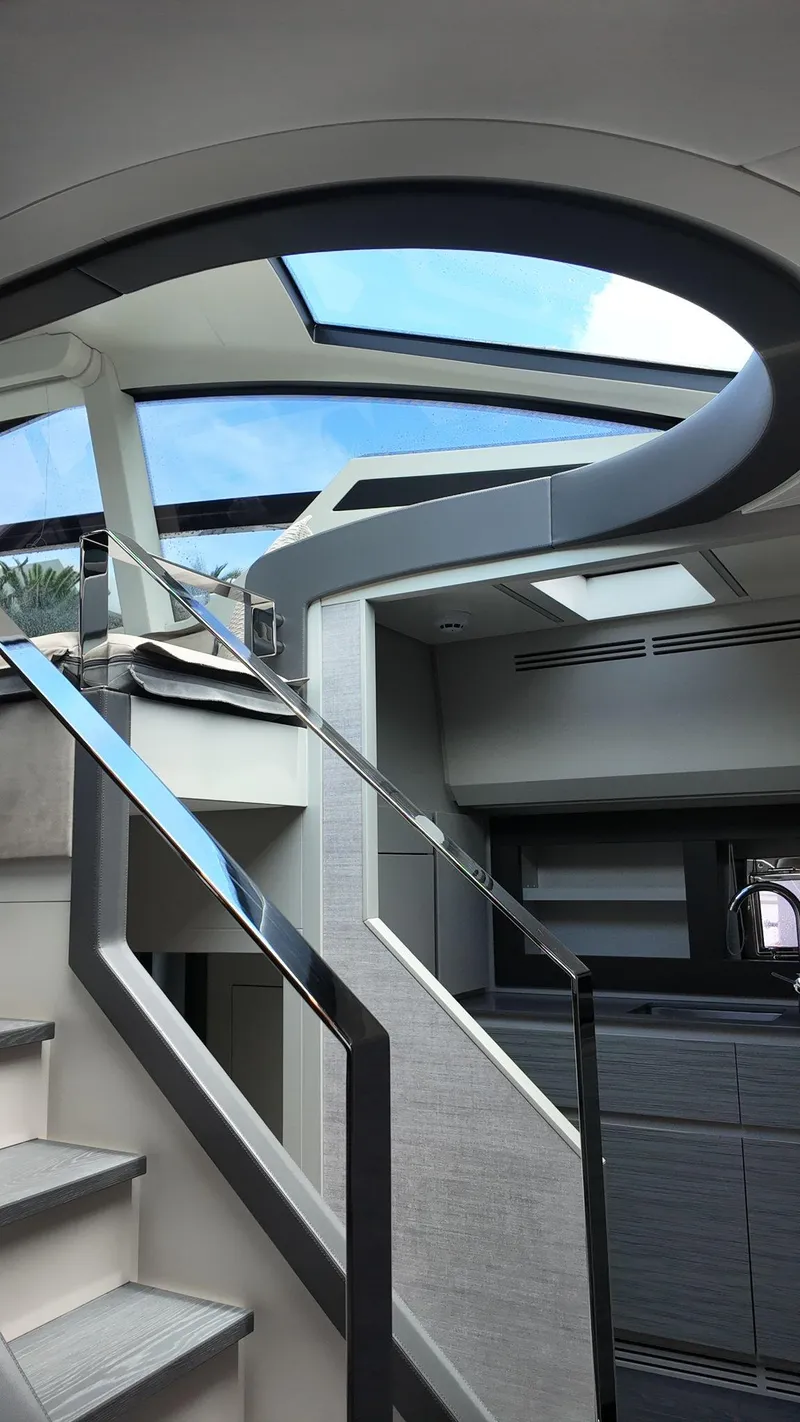 Slide: The Image of Interior view of 2022 Pershing 6X yacht with modern staircase and skylight. - 30