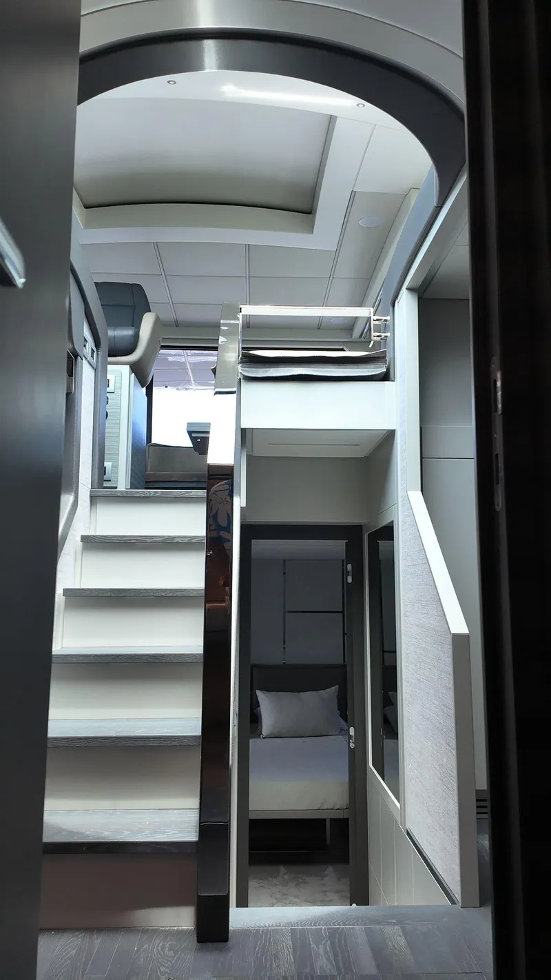 Slide: The Image of Interior of 2022 Pershing 6X yacht, featuring modern staircase and sleek design elements. - 32