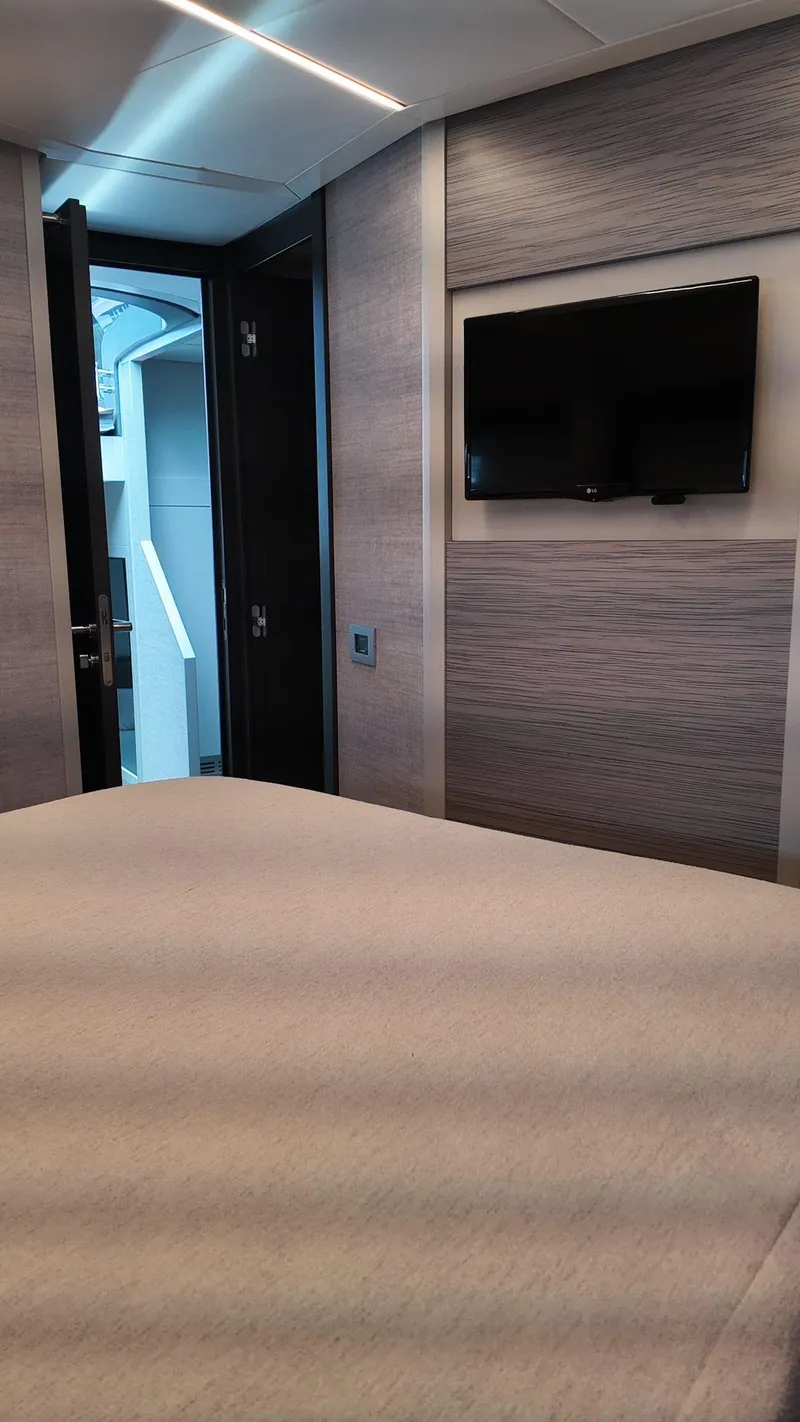 Slide: The Image of Interior of 2022 Pershing 6X yacht cabin with modern decor and wall-mounted TV. - 33