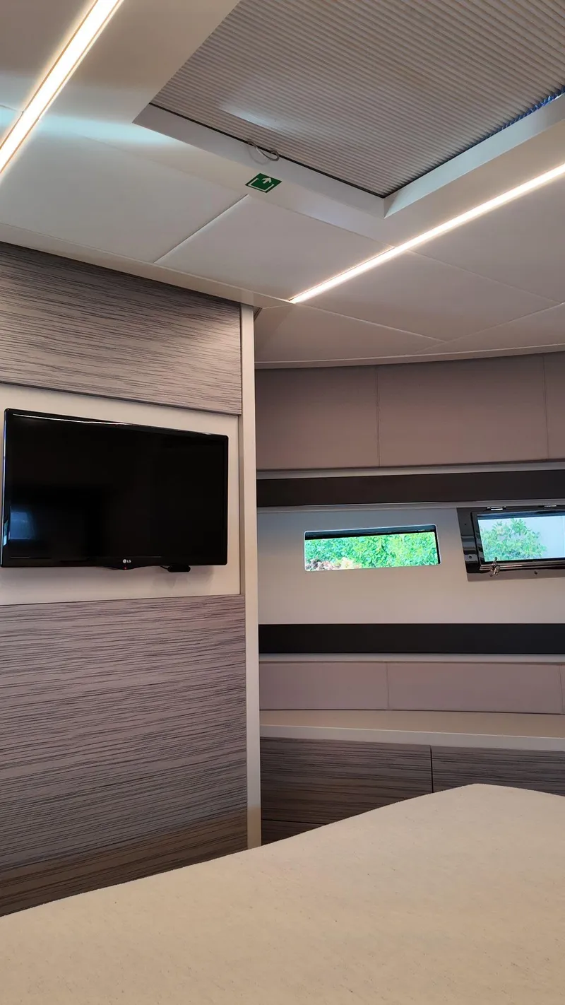Slide: The Image of Interior of 2022 Pershing 6X yacht with modern design, TV, and windows. - 34