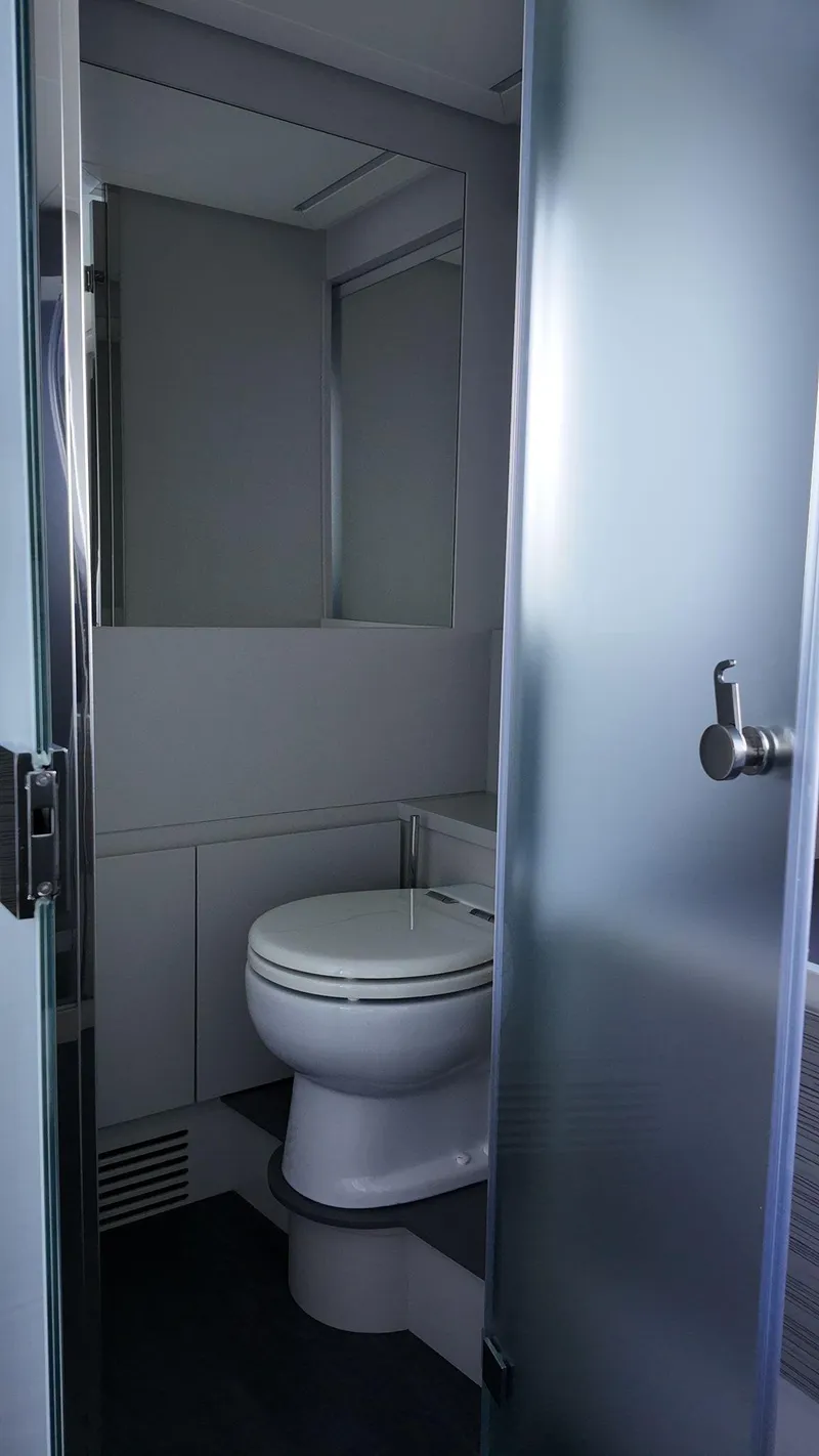 Slide: The Image of Modern bathroom in 2022 Pershing 6X yacht with frosted glass door and sleek design. - 37