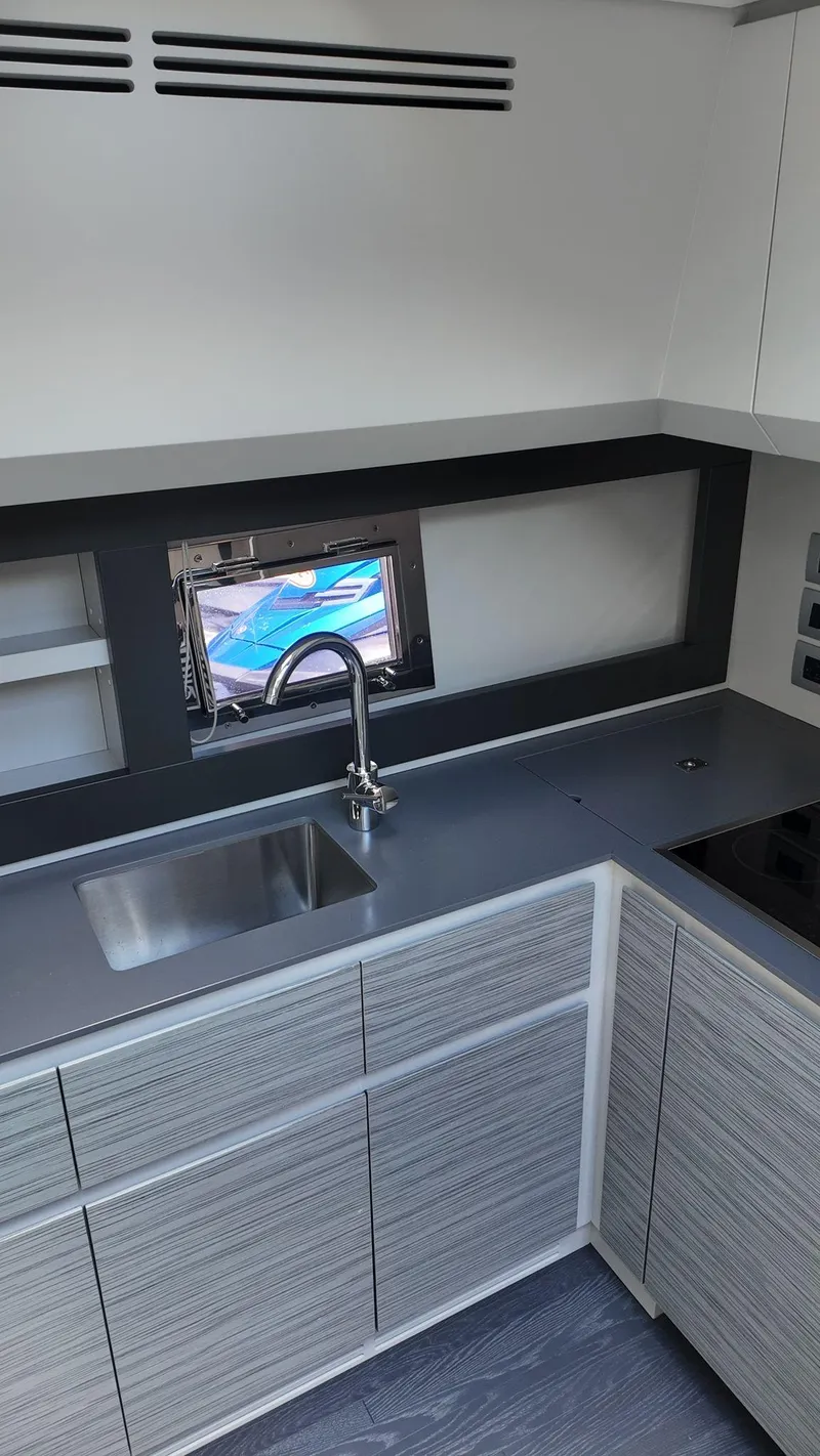 Slide: The Image of Modern kitchen interior of 2022 Pershing 6X yacht with sleek cabinetry and stainless steel sink. - 43