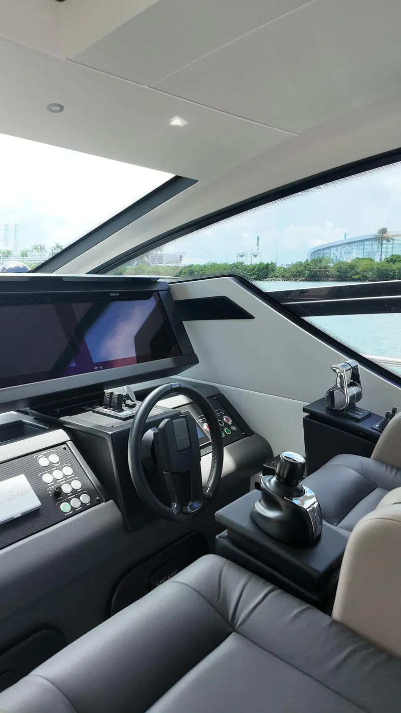 Slide: The Image of Interior of 2022 Pershing 6X yacht cockpit with modern controls and steering wheel. - 44