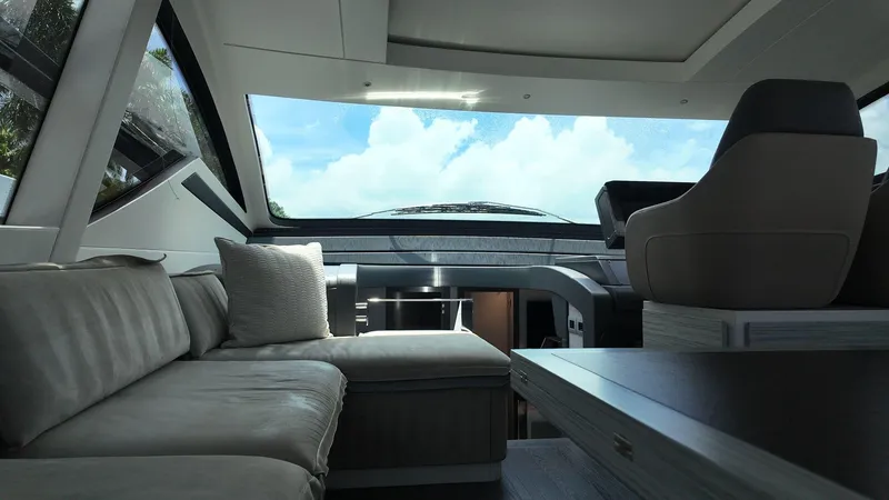 Slide: The Image of Luxurious interior of 2022 Pershing 6X yacht with modern seating and panoramic windows. - 5