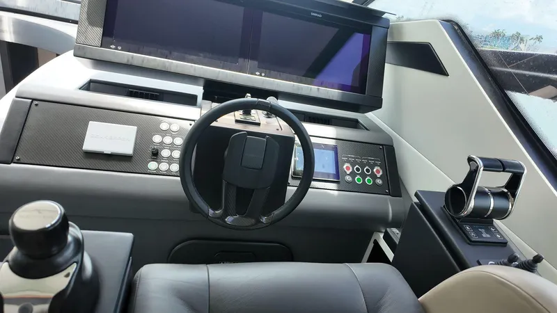 Slide: The Image of Cockpit of 2022 Pershing 6X yacht with modern steering and control panels. - 9