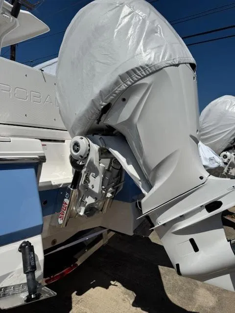 Slide: The Image of 2025 Robalo 246 Cayman boat with covered outboard motor, showcasing sleek design and modern features. - 11