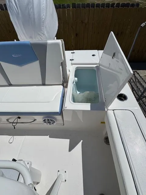 Slide: The Image of 2025 Robalo 246 Cayman boat interior with open storage compartment and seating. - 16