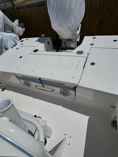 Slide: The Image of 2025 Robalo 246 Cayman boat deck with covered engine and storage compartments. - 17