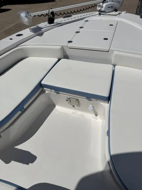 Slide: The Image of 2025 Robalo 246 Cayman boat interior with white seating and storage compartments. - 23