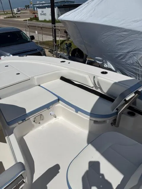 Slide: The Image of 2025 Robalo 246 Cayman boat interior with white seating and storage compartments. - 25