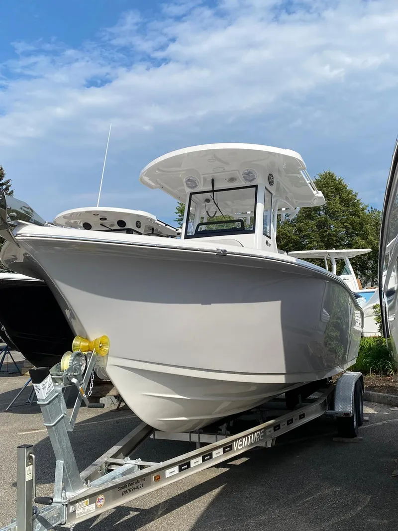Slide: The Image of 2025 Sea Pro 242 Center Console boat on trailer under blue sky. - 1