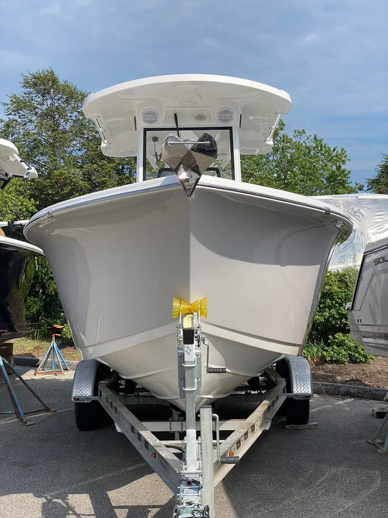 Slide: The Image of 2025 Sea Pro 242 Center Console boat on trailer, front view, outdoors. - 2