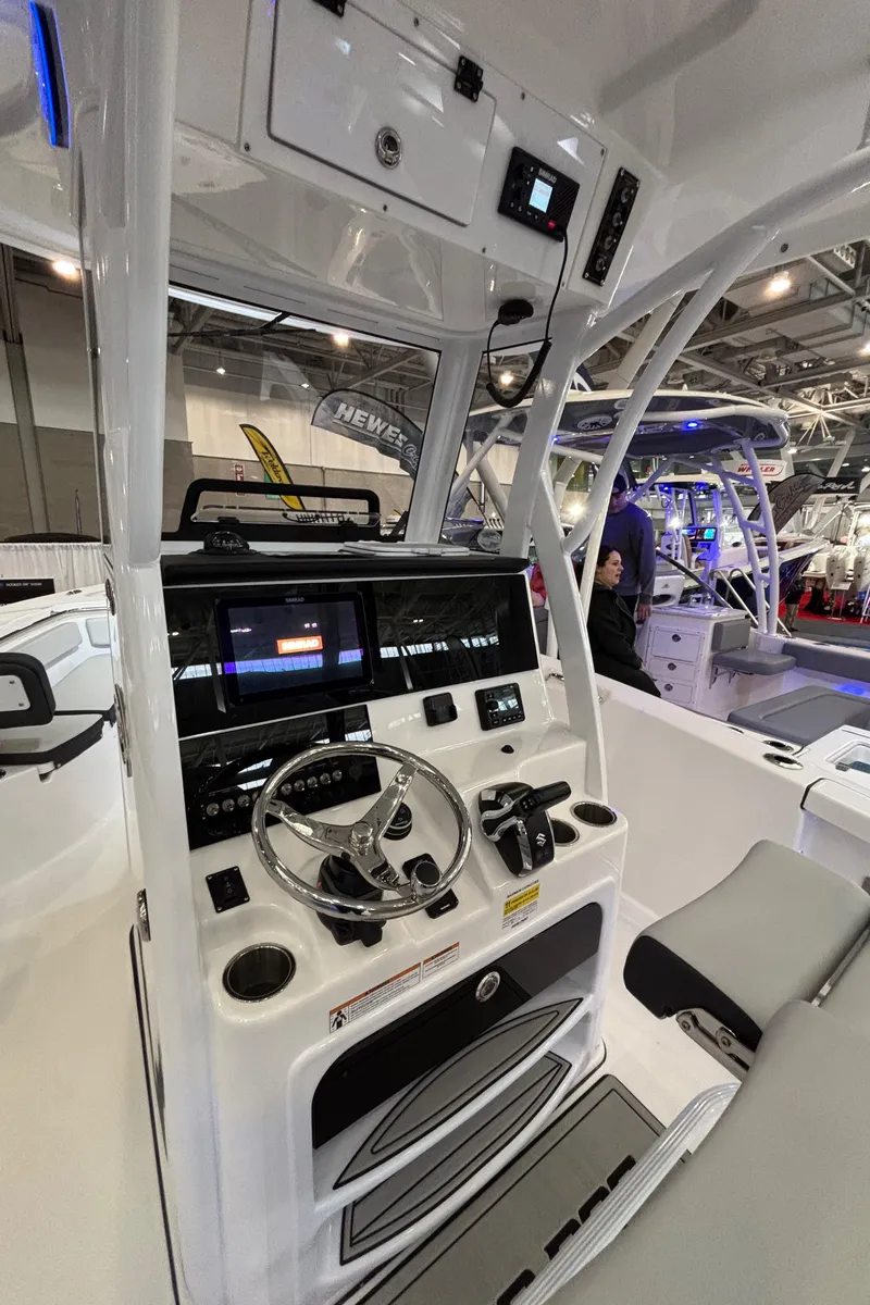 Slide: The Image of 2025 Sea Pro 242 Center Console boat interior with modern dashboard and controls. - 9