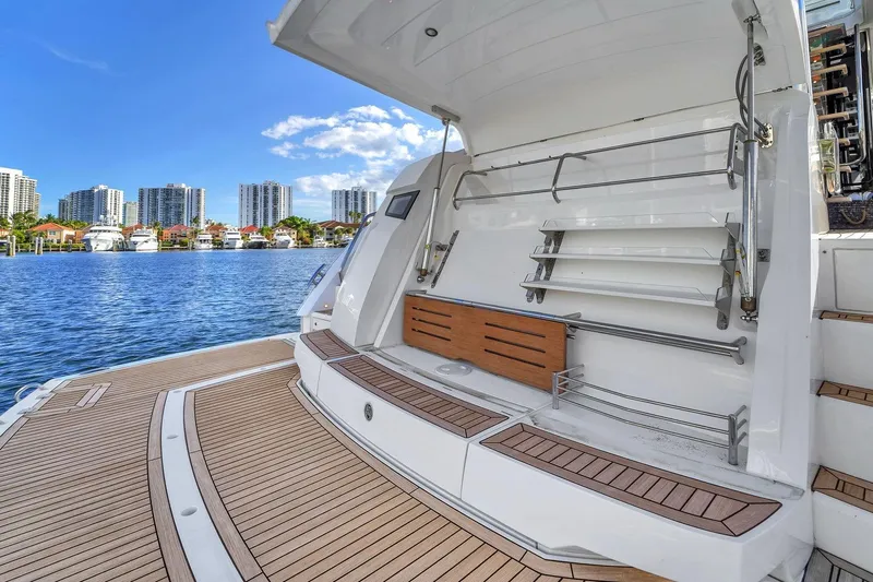 Slide: The Image of 2023 Sunseeker Manhattan 68 Pacific yacht with open deck, city skyline in background. - 37