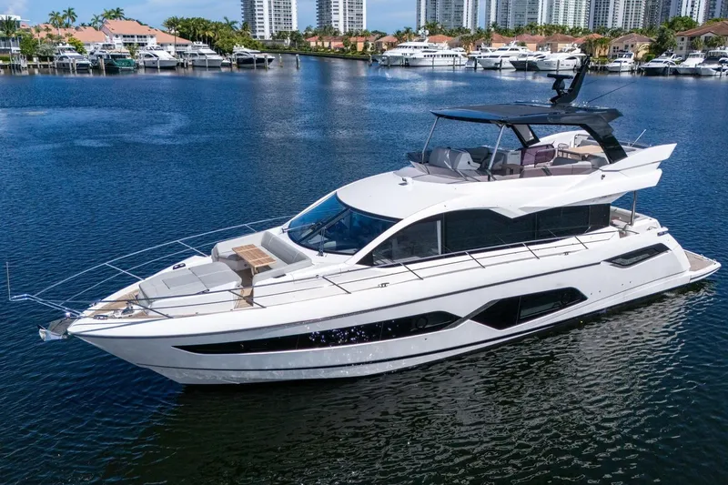 Slide: The Image of 2023 Sunseeker Manhattan 68 Pacific yacht on serene water, showcasing luxury design. - 6