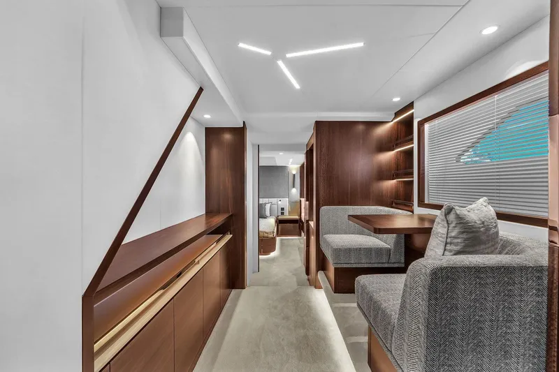 Slide: The Image of Luxurious interior of 2023 Sunseeker Manhattan 68 Pacific yacht with modern seating and elegant wood finishes. - 64