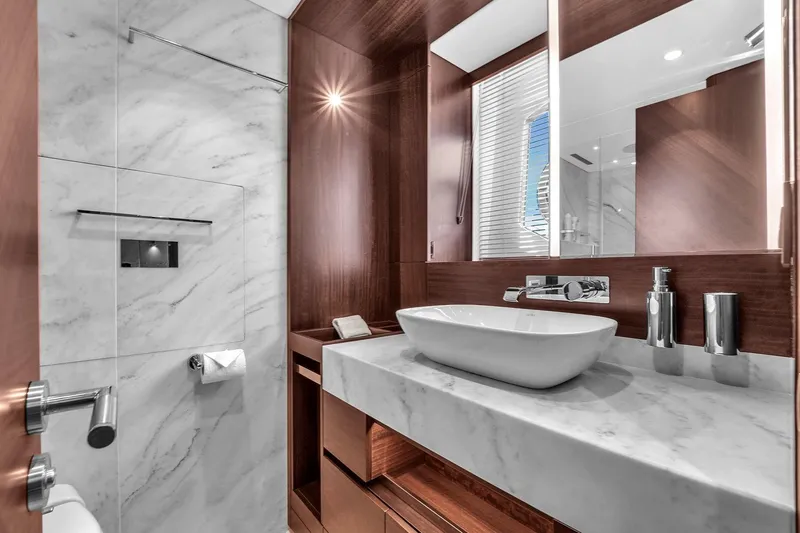 Slide: The Image of Luxurious bathroom in 2023 Sunseeker Manhattan 68 Pacific yacht, featuring marble and wood finishes. - 73