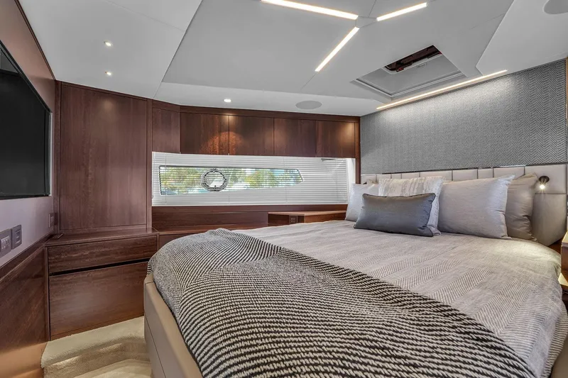 Slide: The Image of Luxurious bedroom interior of 2023 Sunseeker Manhattan 68 Pacific yacht, featuring elegant wood finishes. - 75