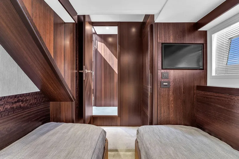 Slide: The Image of Luxurious interior of 2023 Sunseeker Manhattan 68 Pacific yacht cabin with twin beds. - 79