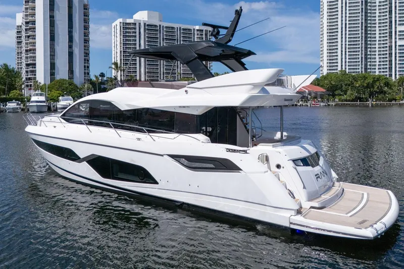 Slide: The Image of 2023 Sunseeker Manhattan 68 Pacific yacht docked near modern high-rise buildings. - 8