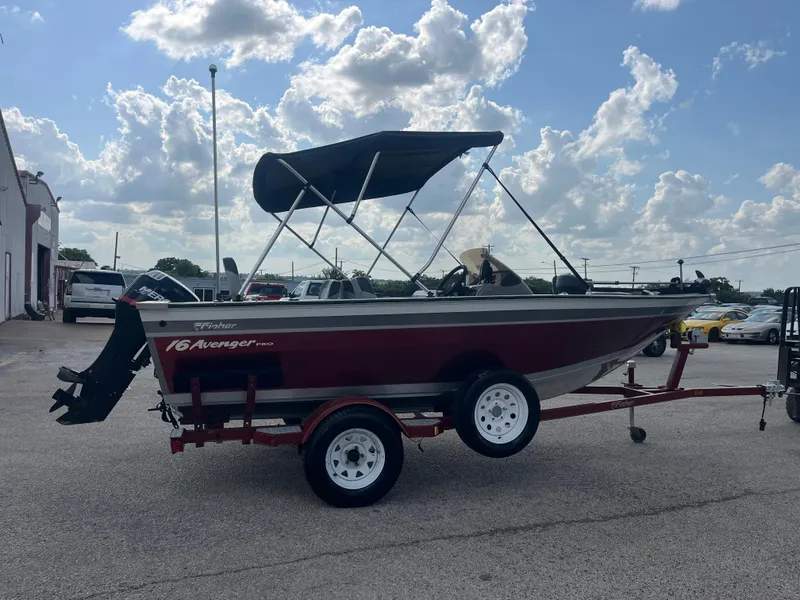 Slide: The Image of 2002 Fisher 16 Pro Avenger boat on red trailer, close-up view. - 17