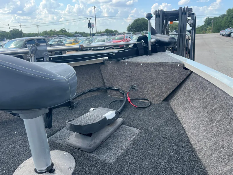 Slide: The Image of 2002 Fisher 16 Pro Avenger boat with Mercury 40 outboard motor, parked outdoors. - 21