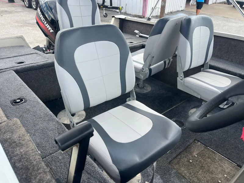 Slide: The Image of 2002 Fisher 16 Pro Avenger boat on trailer, parked outdoors under a blue sky. - 22