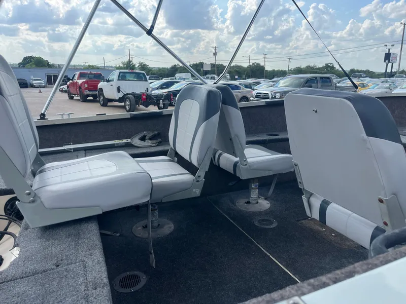 Slide: The Image of Interior of a 2002 Fisher 16 Pro Avenger boat with seating and controls. - 24