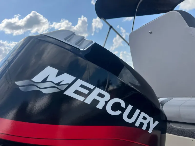 Slide: The Image of Steering console of 2002 Fisher 16 Pro Avenger boat under a cloudy sky. - 26