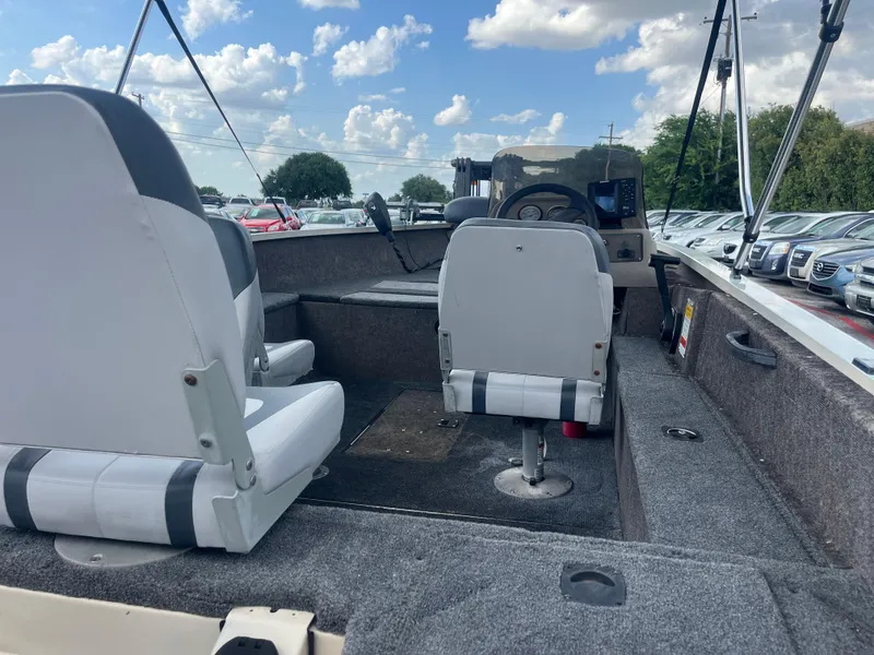 Slide: The Image of 2002 Fisher 16 Pro Avenger boat interior with gray seating and carpeted floor. - 27