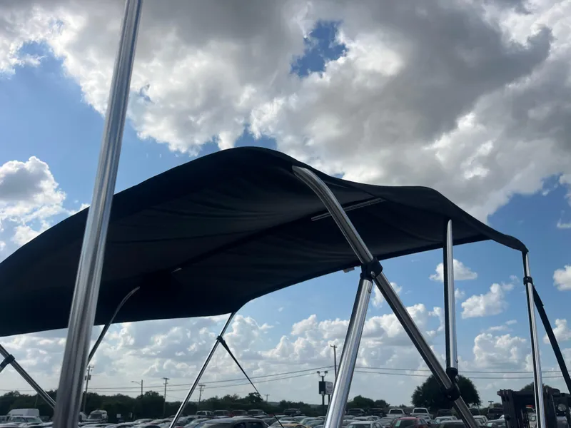 Slide: The Image of Interior of a 2002 Fisher 16 Pro Avenger boat with steering wheel and seating. - 32