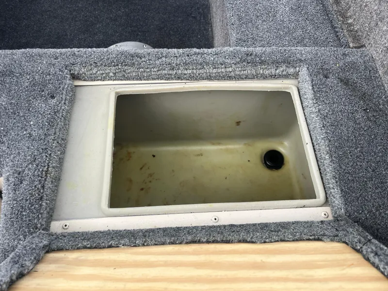 Slide: The Image of 2002 Fisher 16 Pro Avenger boat interior with seating and equipment under a cloudy sky. - 33