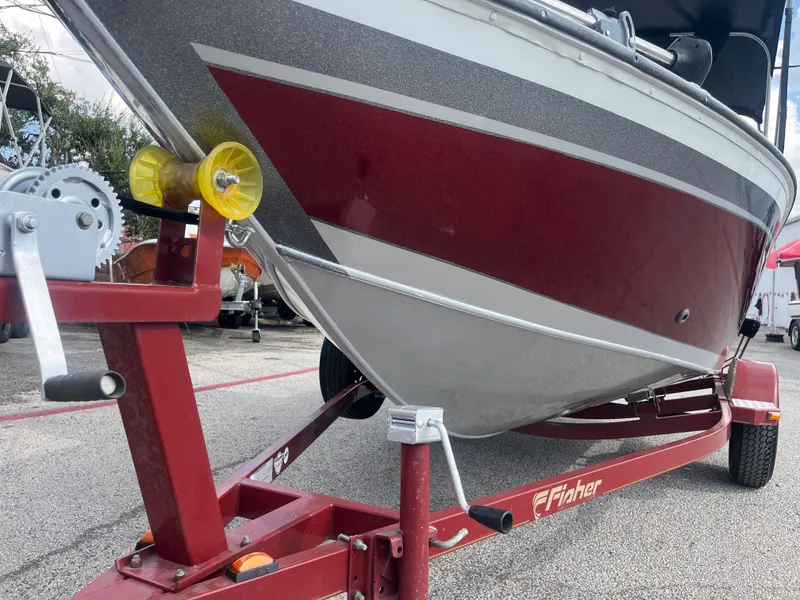 Slide: The Image of 2002 Fisher 16 Pro Avenger boat with Mercury outboard motor on trailer. - 4