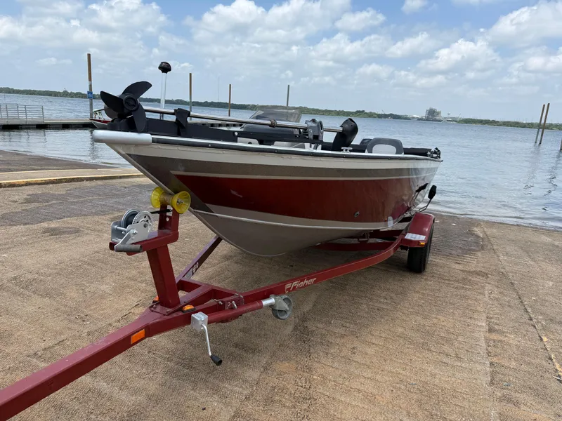 Slide: The Image of Open storage compartment in 2002 Fisher 16 Pro Avenger boat, featuring carpeted interior. - 44