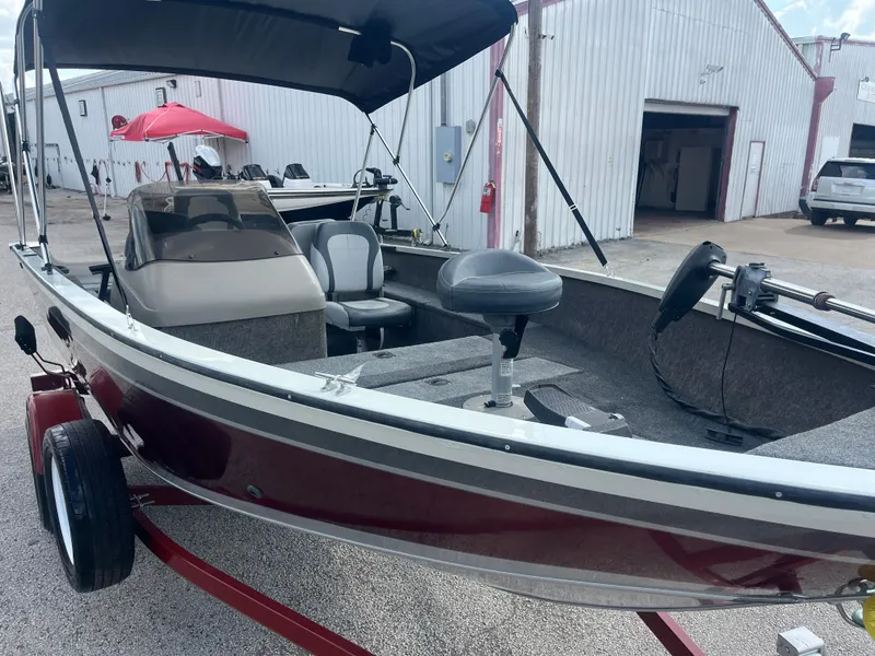 Slide: The Image of 2002 Fisher 16 Pro Avenger boat on red trailer, close-up view. - 9