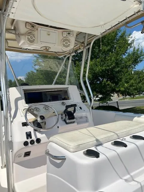 Slide: The Image of 2005 Pro-Line 29 Super Sport boat cockpit with steering wheel and controls, sunny day. - 2