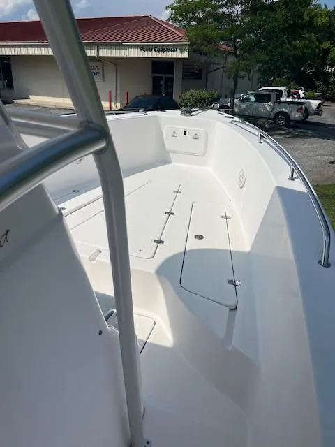 Slide: The Image of 2005 Pro-Line 29 Super Sport boat deck, featuring sleek white design and spacious layout. - 4