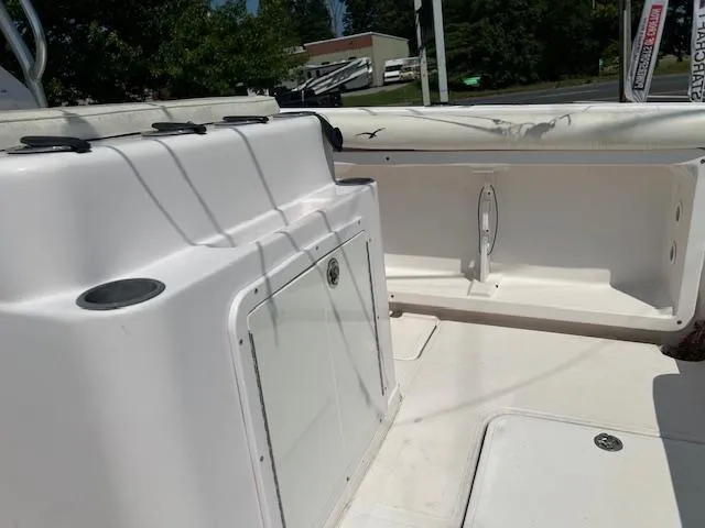 Slide: The Image of 2005 Pro-Line 29 Super Sport boat interior with storage compartments and seating area. - 6