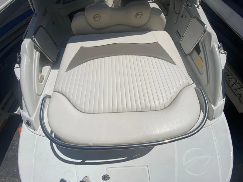 Slide: The Image of 2006 Crownline 320 LS boat interior with white cushioned seating and chrome accents. - 10