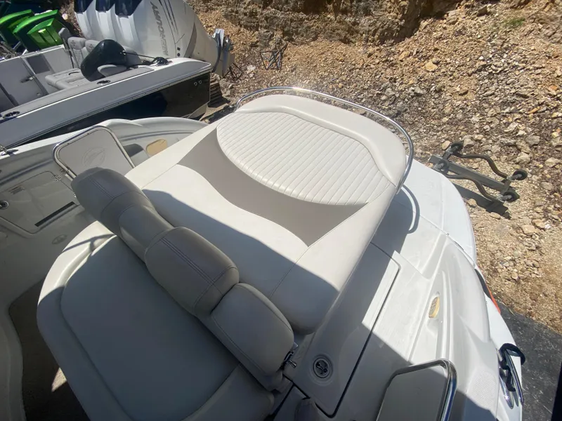 Slide: The Image of 2006 Crownline 320 LS boat with white leather seating and sleek design. - 11