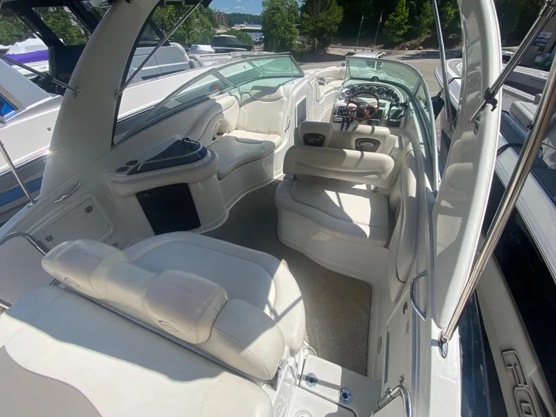 Slide: The Image of 2006 Crownline 320 LS boat interior with white seating and modern dashboard. - 12