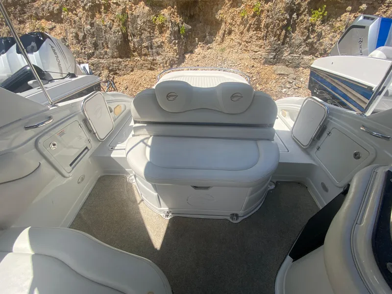 Slide: The Image of 2006 Crownline 320 LS boat interior with white seating and storage compartments. - 13