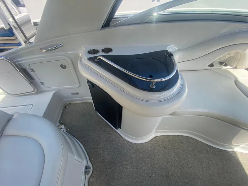 Slide: The Image of Interior of a 2006 Crownline 320 LS boat, featuring seating and storage areas. - 16