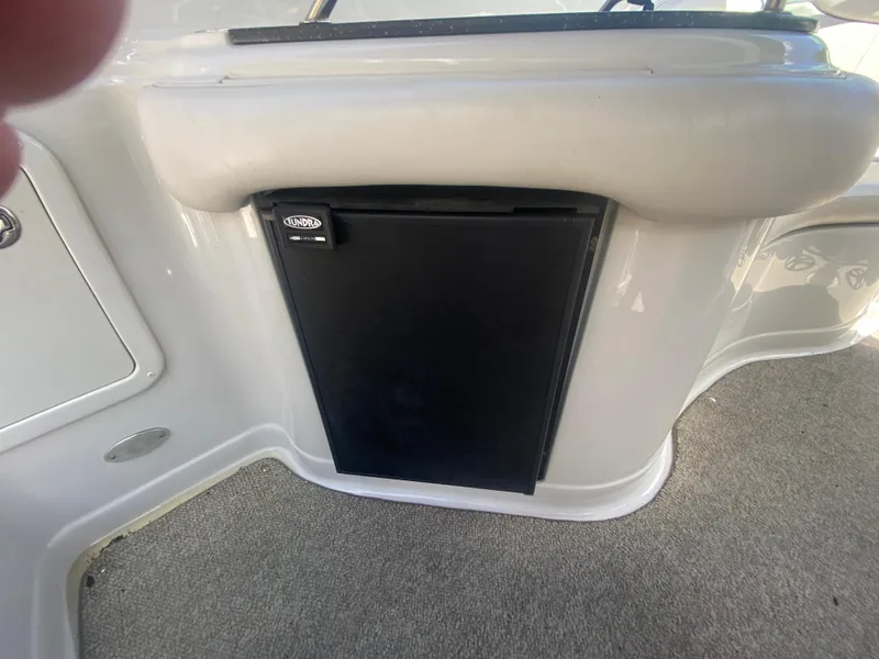 Slide: The Image of 2006 Crownline 320 LS boat interior with a built-in Lund refrigerator. - 18