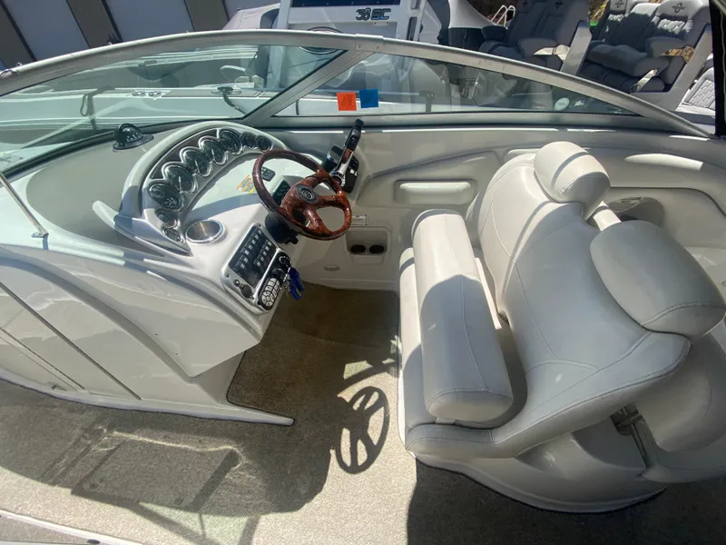 Slide: The Image of Interior of 2006 Crownline 320 LS boat with white seating and modern dashboard. - 22