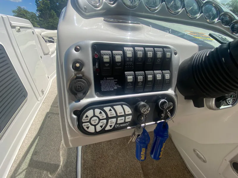 Slide: The Image of Control panel of a 2006 Crownline 320 LS boat with switches and keys. - 27