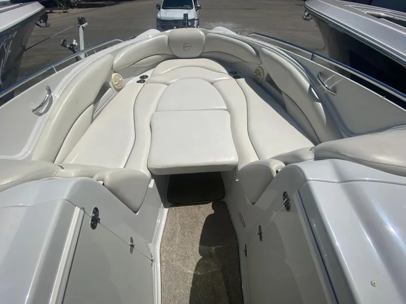 Slide: The Image of 2006 Crownline 320 LS boat interior with white seating and spacious layout. - 29