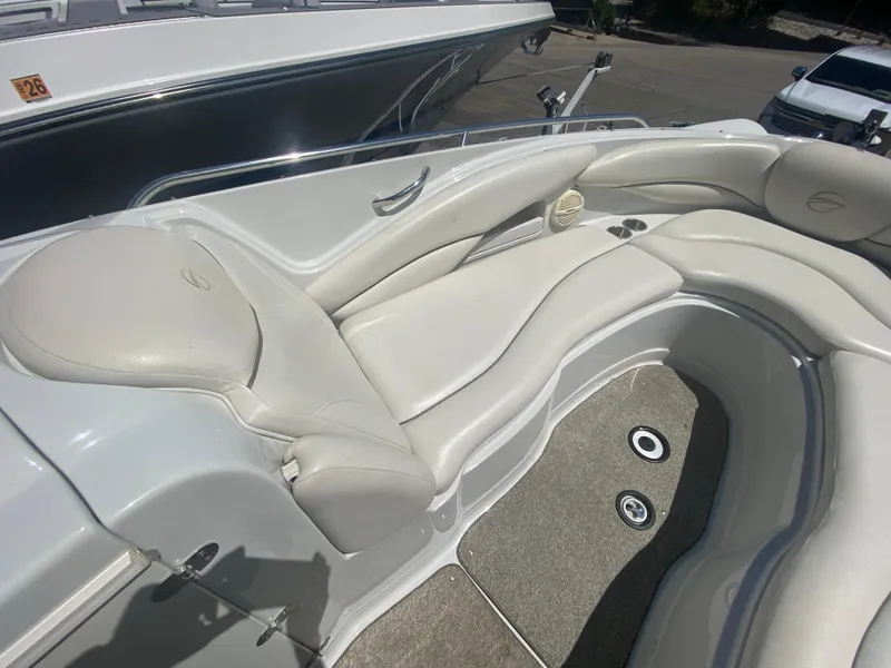 Slide: The Image of 2006 Crownline 320 LS boat interior with white leather seating and carpeted flooring. - 30